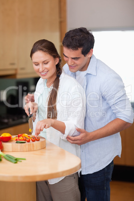 Portrait of a man teaching how to cook to his wife