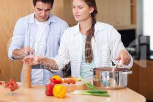 Cute couple using a tablet computer to cook