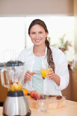 Portrait of a woman drinking fresh fruits juice