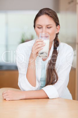 Portrait of a smiling woman drinking milk
