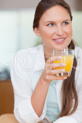 Portrait of a happy woman drinking juice