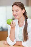 Portrait of a smiling woman with an apple