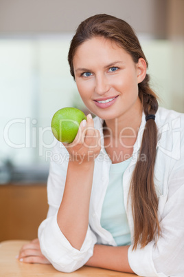 Portrait of a happy woman with an apple