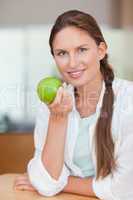 Portrait of a happy woman with an apple
