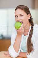 Portrait of a woman eating an apple