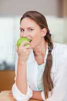 Portrait of a healthy woman eating an apple