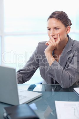Portrait of a thoughtful businesswoman working with a laptop