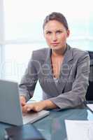 Portrait of a serious businesswoman working with a laptop