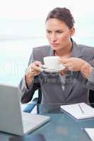 Portrait of a serious businesswoman drinking tea