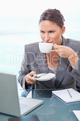 Portrait of a young businesswoman drinking tea