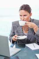 Portrait of a young businesswoman drinking tea