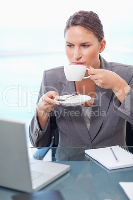 Portrait of a serious businesswoman drinking coffee Portrait of a serious businesswoman drinking coffee