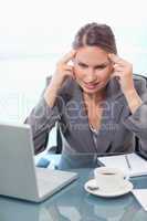 Portrait of an upset businesswoman having a headache