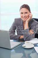 Portrait of a smiling businesswoman working with a notebook