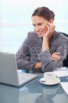 Portrait of a happy businesswoman working with a notebook