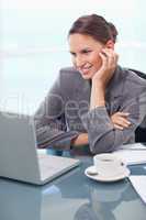 Portrait of a happy businesswoman working with a notebook