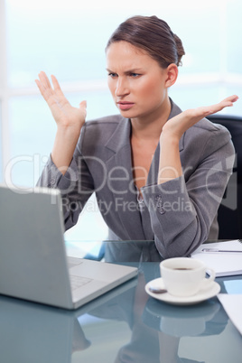 Portrait of an upset businesswoman working with a notebook