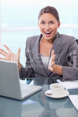 Portrait of a surprised businesswoman working with a notebook