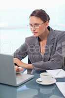 Portrait of a focused businesswoman using a laptop