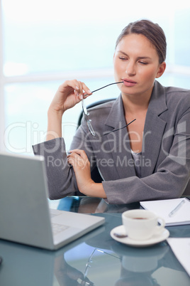 Portrait of a thoughtful businesswoman using a laptop