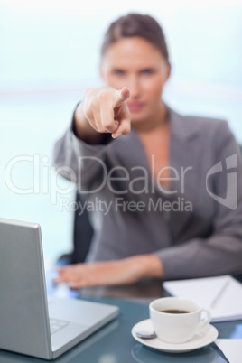 Portrait of a businesswoman pointing at the viewer