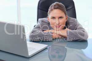Businesswoman leaning on her desk