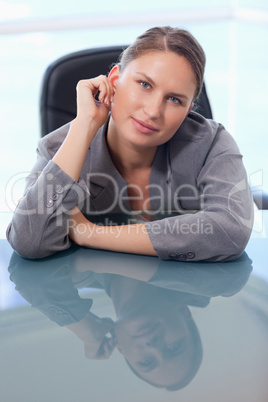 Portrait of a businesswoman leaning on her desk