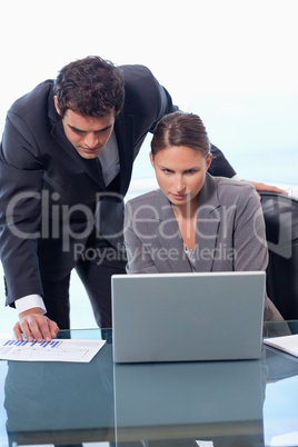 Portrait of a business team working with a laptop