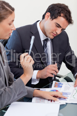 Portrait of a concentrated business team studying statistics