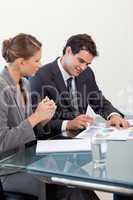 Portrait of a smiling business team studying statistics