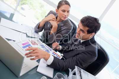 Business team studying statistics with a laptop