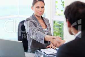 Businesswoman shaking hands with customer