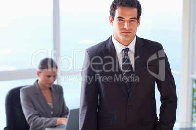 Businessman with his secretary behind him