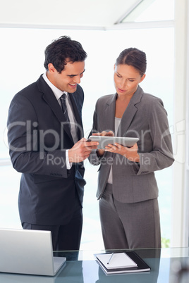 Business partner looking at tablet together