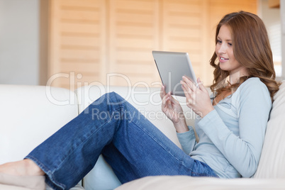 Woman reading e-book on the sofa
