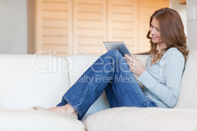 Woman reading e-book on the couch