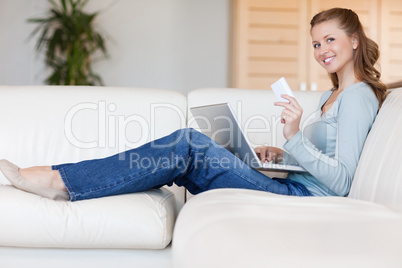 Woman on sofa placing an order online