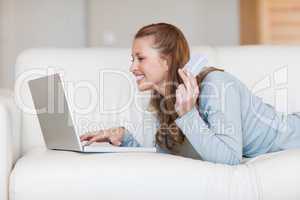 Cheerful smiling woman shopping online