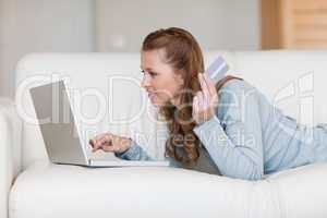 Female online shopper on her sofa