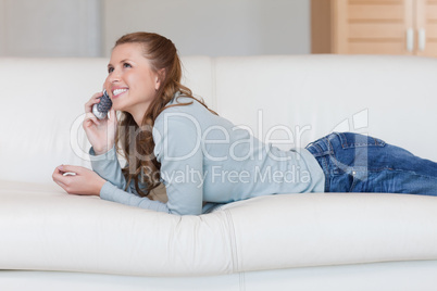 Young woman on the sofa having a nice conversation on the phone