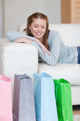 Young woman taking a moment off on her couch after a shopping to
