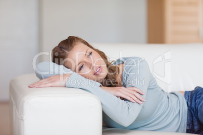 Woman daydreaming on the sofa