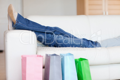 Woman relaxing on the sofa after shopping tour