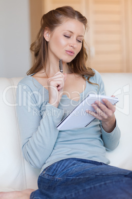 Woman on the sofa reading her notes