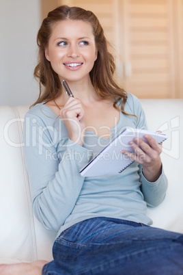 Smiling woman writing down notes