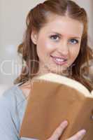 Close up of young woman with a book