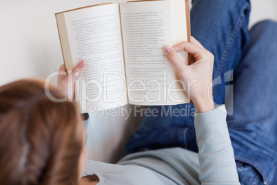 Shadowing woman reading on the sofa