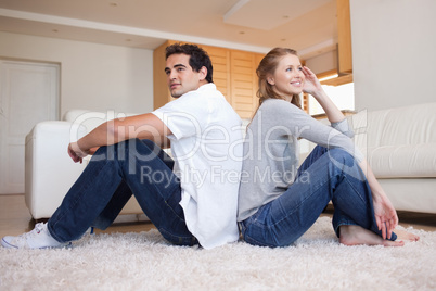 Side view of couple sitting back-to-back