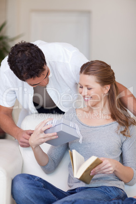 Man handing over present to his girlfriend