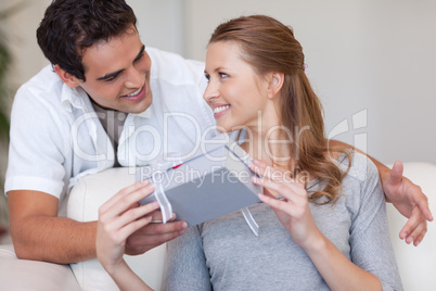 Woman smiling happily about the present she just got from her bo